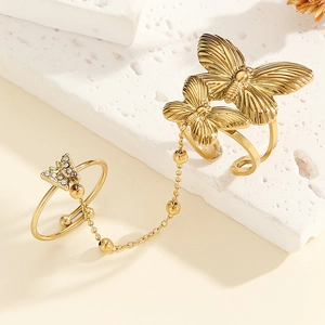 Detailed view of a gold-tone butterfly chain ring with intricate wings and pavé stones