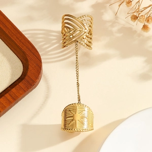 Detail of bohemian gold chain ring featuring hollow weave pattern and starburst relief
