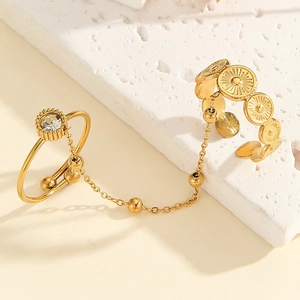 Detail view of gold butterfly chain double ring with bohemian textured coin patterns