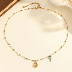 Ocean-inspired gold beaded necklace featuring shell and fish pendants for resort wear