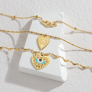 Collier multicouche en acier inoxydable doré avec pendentifs cœur et œil du diable