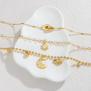 Layered stainless steel necklace set with moon star, cross, and celestial charms