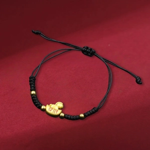 Handcrafted black braided bracelet with a golden sycee ingot and festive red lettering