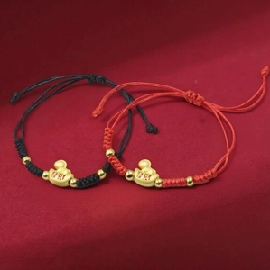 Handcrafted woven red and black rope bracelet with gold ingot and wealth charm