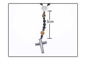 Detailed macro view of 3cm grey metal cross pendant with tiger eye beads necklace