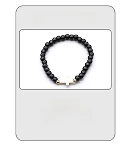 Detail of lightweight beaded bracelet weighing only 9g with black beads and white cross
