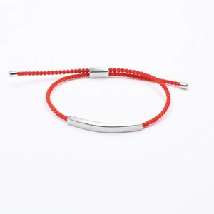 Adjustable red woven cord bracelet with a polished curved stainless steel tube
