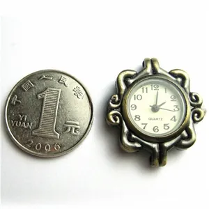 Detail of vintage bronze quartz watch face with relief patterns next to a coin for scale
