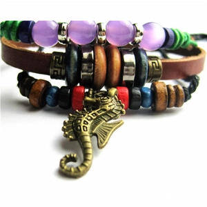 Detailed view of multilayer leather bracelet with colorful beads and seahorse charm pendant