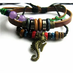 Detailed macro view of bohemian leather bracelet featuring seahorse charm and colorful beads