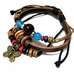 Detail of bohemian multilayer leather bracelet featuring colorful beads and butterfly charm