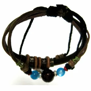 Detail of bohemian multilayer leather bracelet with turquoise beads and wooden rings