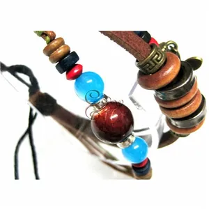 Detailed close-up of multilayer leather bracelet with ethnic beads and bronze accents