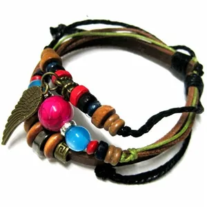 Macro detail of multilayer leather bracelet with feather charm and colorful beads
