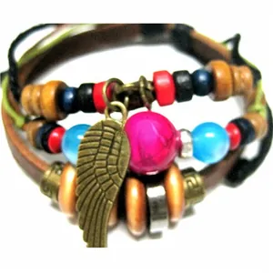 Macro detail of multilayer leather bracelet with bronze feather pendant and colored beads