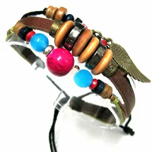 Detail view of multilayer bohemian leather bracelet featuring wing charm and colored beads
