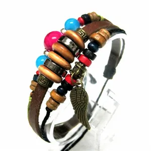 Detail view of multilayer leather bracelet with colorful beads and bronze wing charm