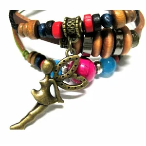 Detailed macro view of bohemian multilayer leather bracelet with fairy charm and colorful beads
