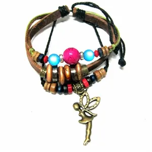 Macro detail of multi-layer leather bracelet featuring colorful beads and fairy pendant charm