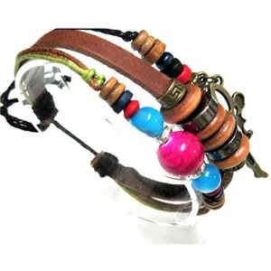 Detail of layered bohemian leather bracelet with colorful beads and bronze charms