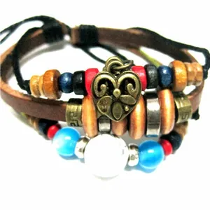 Detail of multi-layered braided leather bracelet with colorful beads and heart pendant