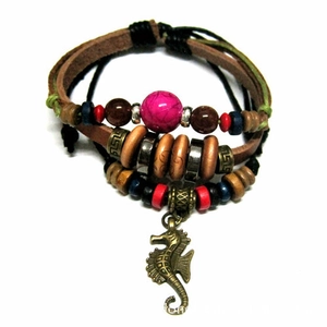 Detail of multi-layer leather bracelet with colorful beads and bronze seahorse pendant