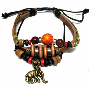 Detail of multilayer leather bracelet with colorful beads and bronze elephant charm pendant