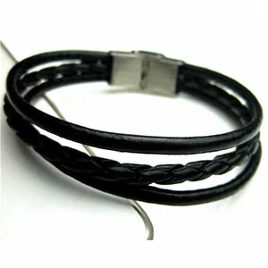 Detail of multi-layer black braided leather bracelet with brushed metal magnetic clasp