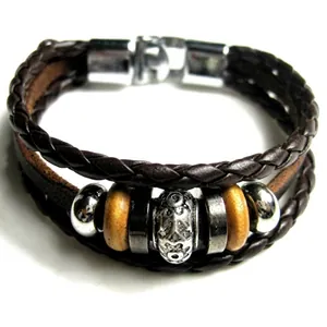 Detail of vintage multilayer braided leather bracelet with anchor beads and metal clasp