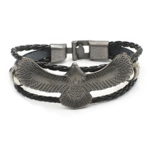 Detail of multi-layer leather bracelet featuring an eagle charm and vintage metal clasp
