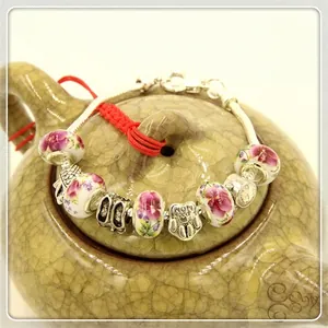 Pandora style ceramic bead bracelet with purple floral patterns and MOM heart charms