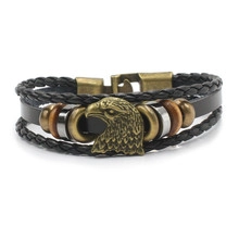 Detail of multi-layer braided leather bracelet with bronze eagle head and metal clasp