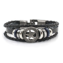 Detail of multi-layer leather bracelet with star metal charm and secure plug-in clasp