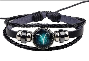 Detail of multi-layer Aries leather bracelet with glass constellation dome and punk style braid