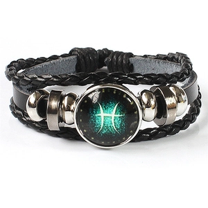 Macro detail of Pisces zodiac multilayer braided leather bracelet with luminous glass charm