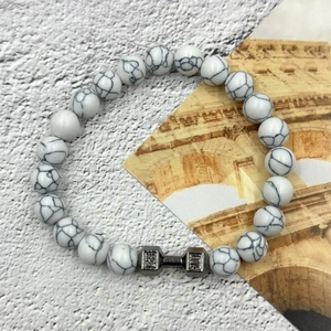 Detailed close-up of white turquoise bead bracelet with silver dumbbell engraved Live Lift