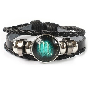 Detail view of multi-layer Scorpio leather bracelet with glowing glass cabochon