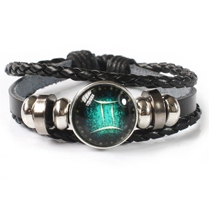 Detailed view of Gemini zodiac multilayer bracelet with leather straps and glass charm
