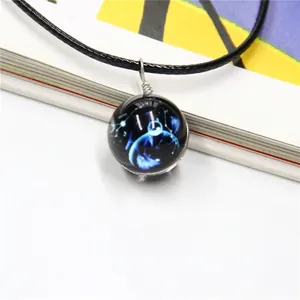 Macro detail of deep blue galaxy glass ball pendant necklace with black wax rope cord