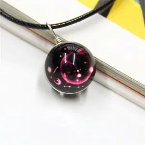 Starry galaxy themed necklace with purple nebula glass ball pendant and black cord