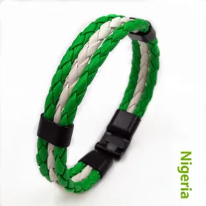 Detail of woven leather Nigeria themed bracelet with green white braid and black clasp