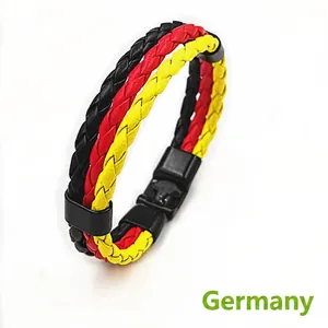 Detail of woven leather bracelet in Germany flag colors with black metal magnetic clasp