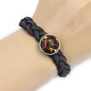 Detail of woven starry sky bracelet with a glass constellation charm on a wrist model