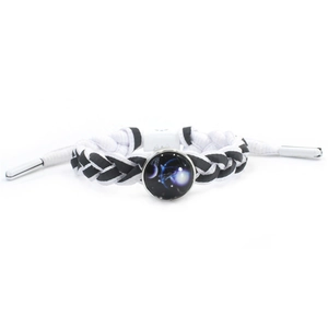 Detail of black and white braided shoelace bracelet with a purple galaxy glass charm