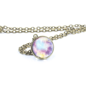 Detailed view of bronze-toned solar system pendant with galaxy nebula glass sphere