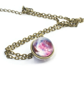 Macro detail of bronze solar system necklace with galaxy pattern in double-sided glass ball