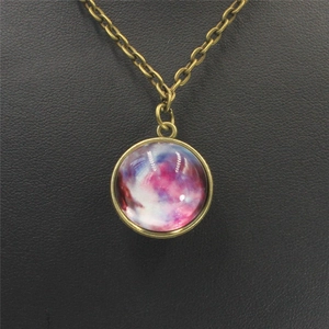 Macro shot of bronze solar system necklace with purple nebula glass dome on leather stand