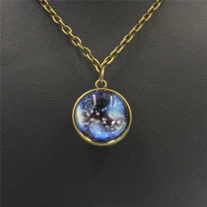 Close-up of vintage bronze necklace featuring a double-sided solar system glass pendant