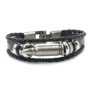 Detail of multi-layer black braided leather bracelet with vintage silver bullet pendant