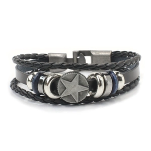Detail of multi-layer leather bracelet with pentagram metal charm and vintage clasp